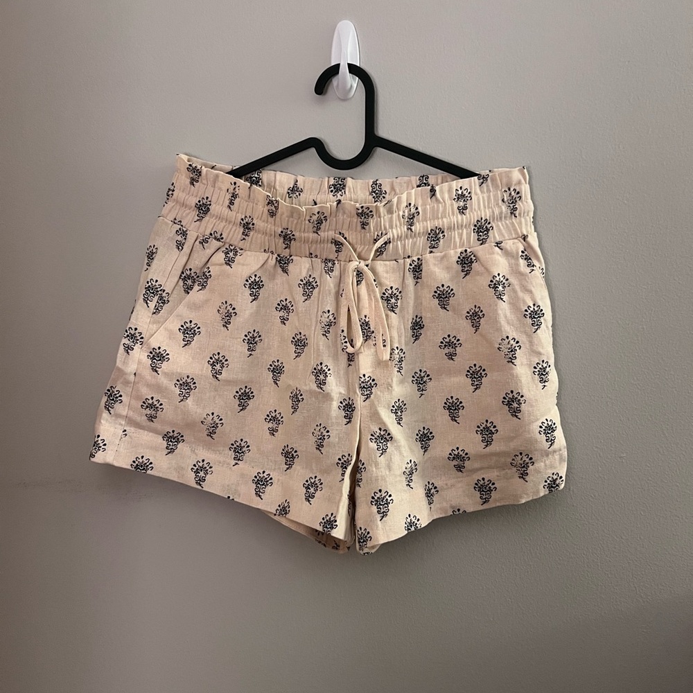 Cream colored shorts with black accent pattern
